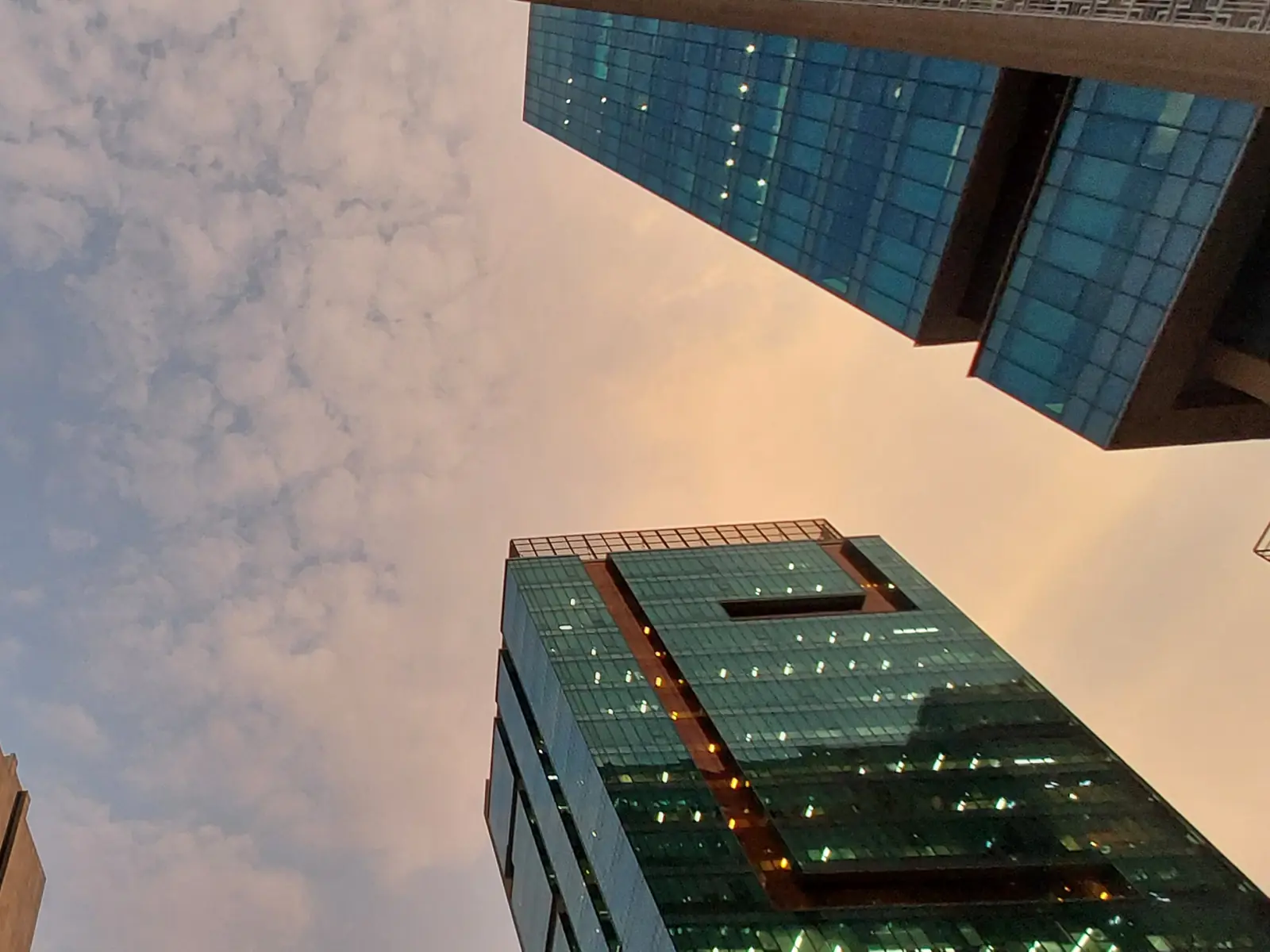 Glass office towers seen from below against an evening sky in Gachibowli, Hyderabad